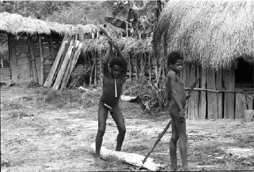 Boys splitting wood