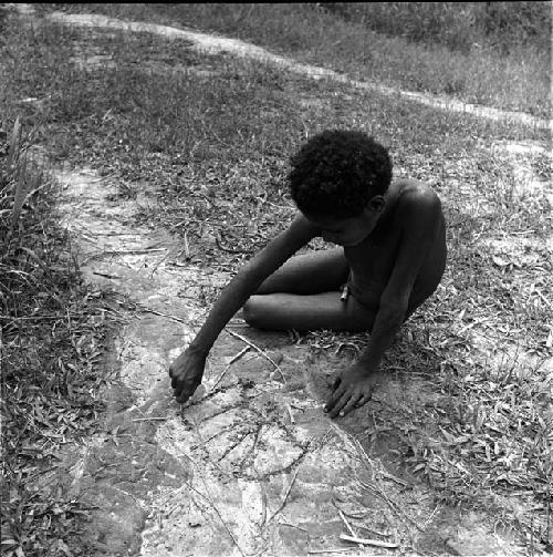 Man drawing in sand