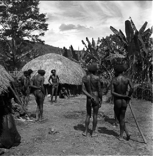 Men mourning in Abukulmo for Eak; Asikanilep faces the camera at a distance