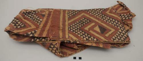 Painted bark cloth costume, top and pants bound together with fiber; staining in groin area; pigment faded and worn. Minor age, some signs of patination but very little.