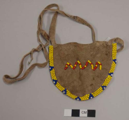 Apron for baby boy; hide with yellow, blue and white beaded pattern on front and back edges; red and yellow beaded zigzag pattern at front center