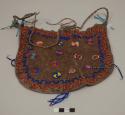 Large leather bag beaded on one side with circular motifs in orange, white, light blue, dark blue and red; orange and dark blue zigzags; pendant strings of small glass beads; long twisted leather strap
