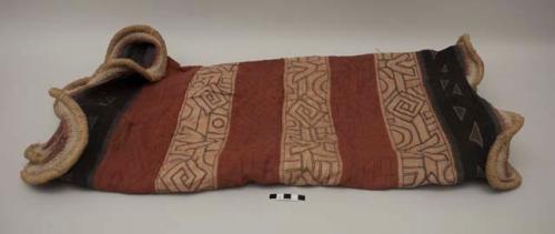 Women's Nchak dance skirt, red and tan panels with black border, undulating edging. Slight bleeding of red dye into tan panels. Minor native repairs. Loose strings. Minor staining on red panels. Small separation on red panel near black border. Excellent example with good age.