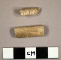 White kaolin pipe stem fragments, one with molded decoration