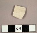 White salt glazed stoneware sherd with incised ribs on exterior