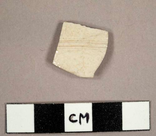 White salt glazed stoneware sherd with incised ribs on exterior