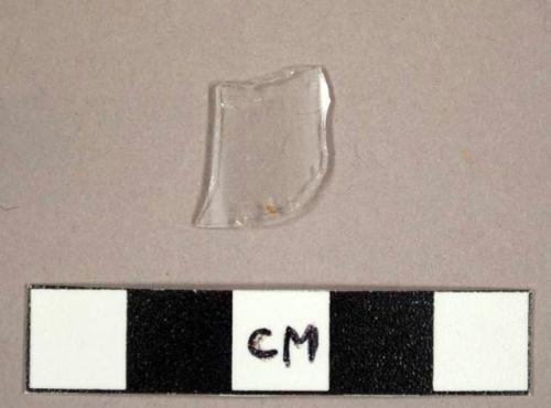 Colorless curved glass fragment, possibly from a hurricane lamp