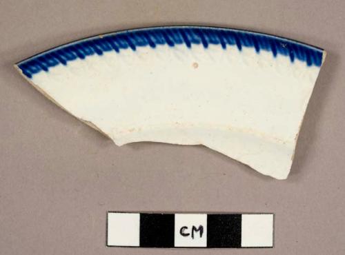 Pearlware rim sherd from a feather-edged plate with a cobalt rim