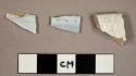 Whiteware sherds, four with blue transfer print and one plate rim sherd