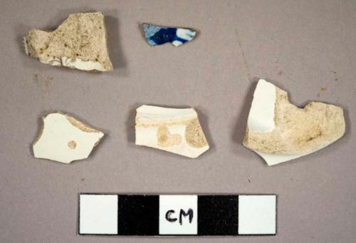 Whiteware sherds, including a plate base sherd and two with transfer printed decoration