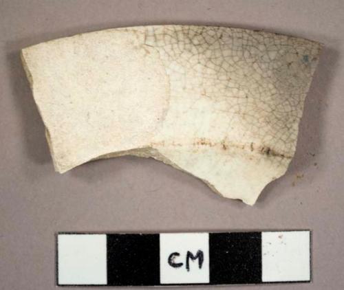 Creamware rim sherd to a plate, burnt