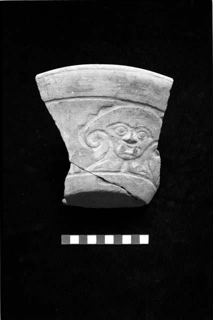 Florero sherd with low relief face from Site 140