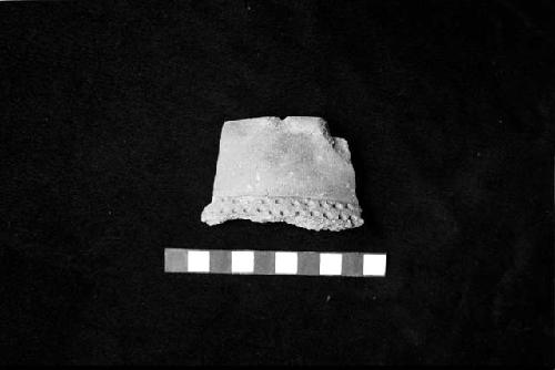 Slightly everted medium neck sherd with neck/shoulder applique rib with punctates from Site 128