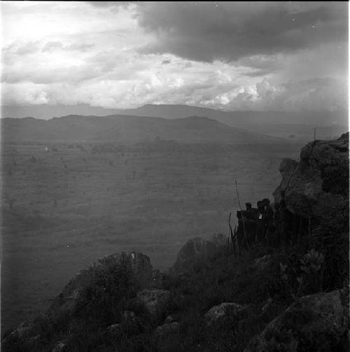 Warriors sheltered by rock face