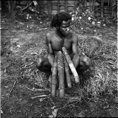 Yege Asuk holding stone adzes