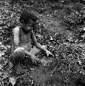 Tukom playing with mud