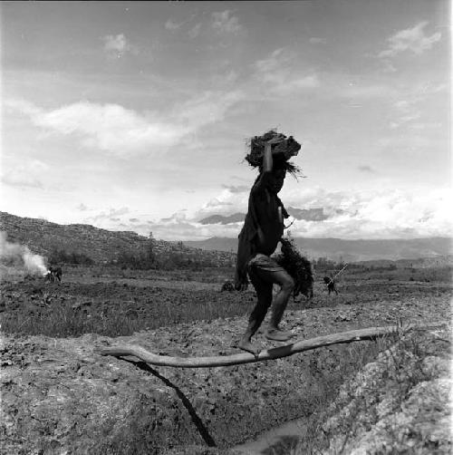 Woman walking across bridge