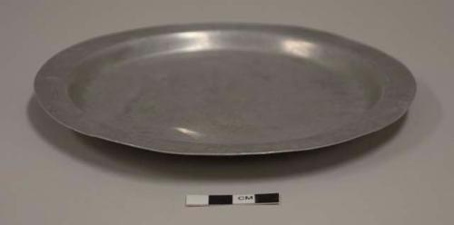 Flat lid for aluminum cooking pot; first, smallest, of set of 12; impressed mark of crossed arrows with crown above, illegible words above and below