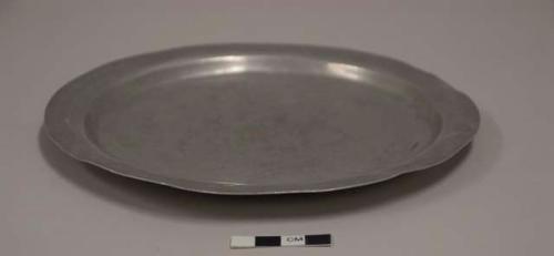 Flat lid for aluminum cooking pot; second of set of 12; impressed mark of crossed arrows with crown above, illegible words above and below