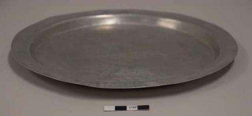 Flat lid for aluminum cooking pot; fourth of set of 12;  impressed mark of airplane with words "TRADE MARK" above and "PURE [ALUMINUM?]" beneath