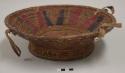 Straw and leather serving bowl; black and red pattern, cowrie shells
