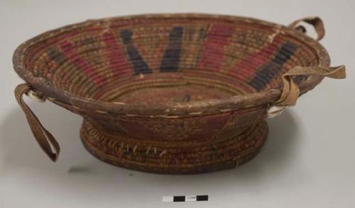 Straw and leather serving bowl; black and red pattern, cowrie shells
