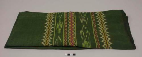 Woman's green longyi with yellow, pink, green thread designs