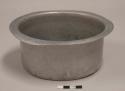 Aluminum cooking pot, round, everted rim; first, smallest, of nesting set of 12 pots with lids; impressed mark of crossed arrows with crown above, illegible words above and below