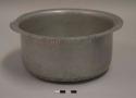 Aluminum cooking pot, round, everted rim; fourth of nesting set of 12 pots with lids;  impressed mark of airplane with words "TRADE MARK" above and "PURE [ALUMINUM?]" beneath