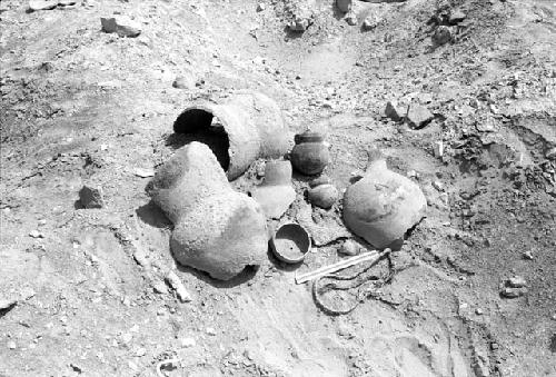 Large vessel fragments, gourd bowl, small ollas, mat fragments and braided rope in south cemetery at Site 146