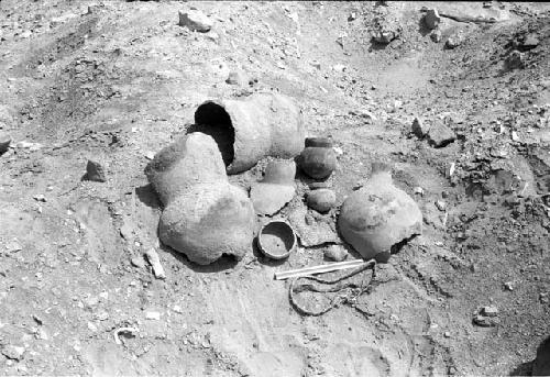 Large vessel fragments, gourd bowl, small ollas, mat fragments and braided rope in south cemetery at Site 146