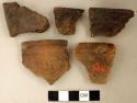 Coarse earthenware rim sherds, some undecorated, one incised, one molded