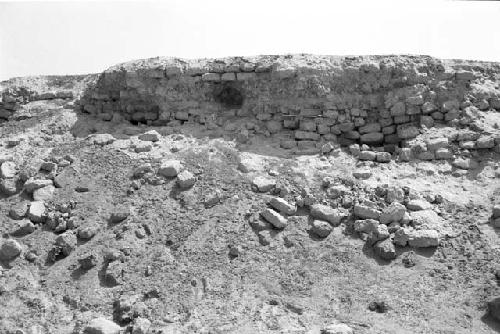 Exposed construction of top of huaca and bevelled outer wall on west side of mound at Site 177