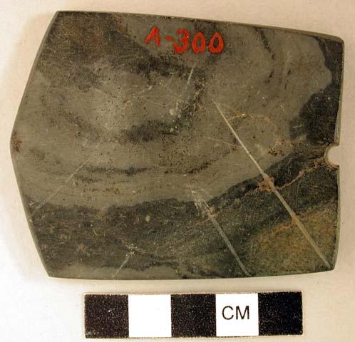 Ground stone object, flat, with perforation, possible gorget fragment; appears to have been broken and reworked