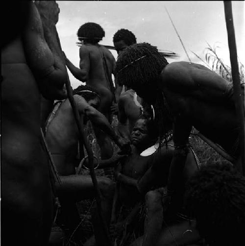 Removing an arrow from boy's shoulder