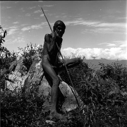 Old man sitting on rocks