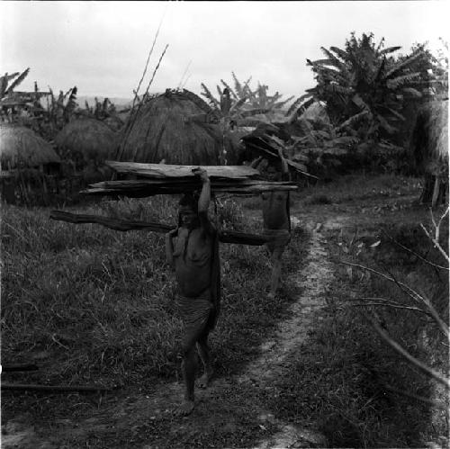 women carrying wood