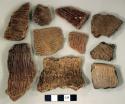Coarse earthenware body and rim sherds, some cord impressed, some incised, some undecorated