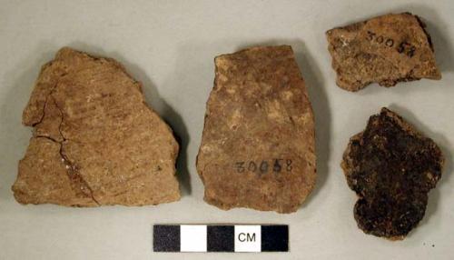 Coarse earthenware body sherds, some undecorated, one cord impressed