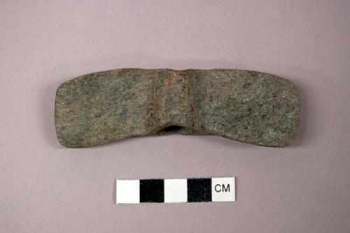 Ground stone atlatl weight, winged