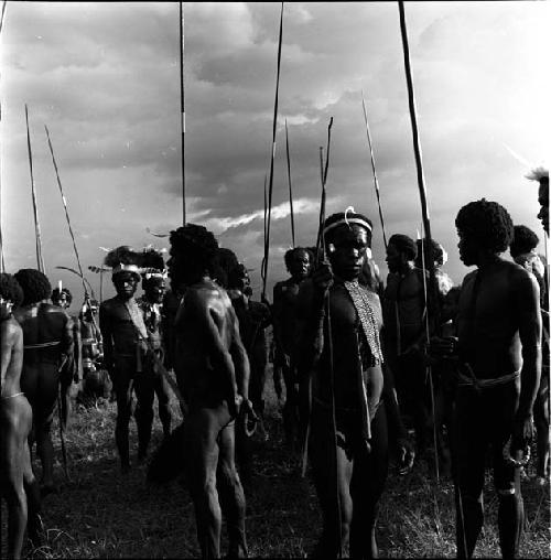 men standing with spears