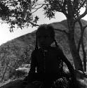 child sitting on a rock