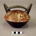 Pottery vessel with 2 divergent spouts and handle; decorated with 2 stylized