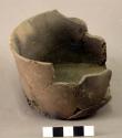 Ceramic jar, plain, cylinder-shaped, slightly rounded base, mended
