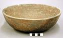 Complete ceramic bowl, red slip, fire-marked