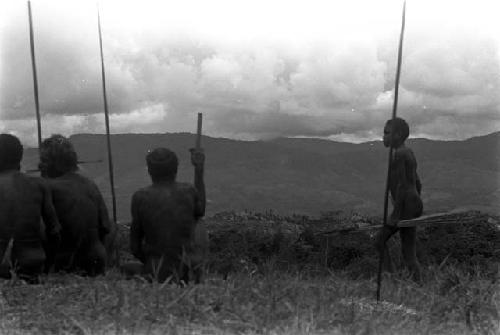 Men looking at the battle from the Warabara