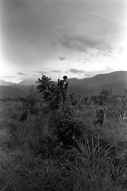 Men washing on the Tokolik; one up in a tree