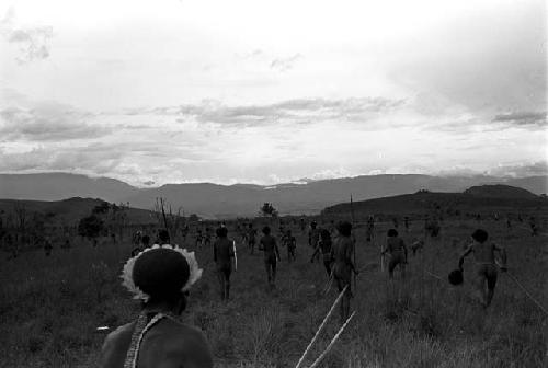 Men in a line at the rear of the battle, watching the battle