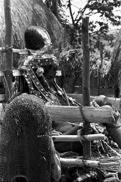 Women near the pia (chair) containing Ekiarotmilek, covered with woven cowrie shell strands