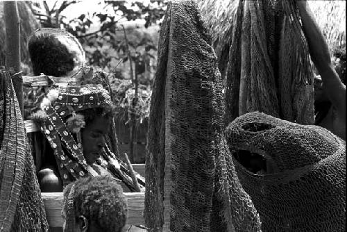 Ekiarotmilek in the decorated pia, women mourning around him